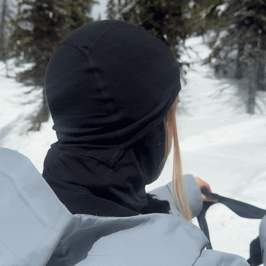 A skier staying warm on a cold lift