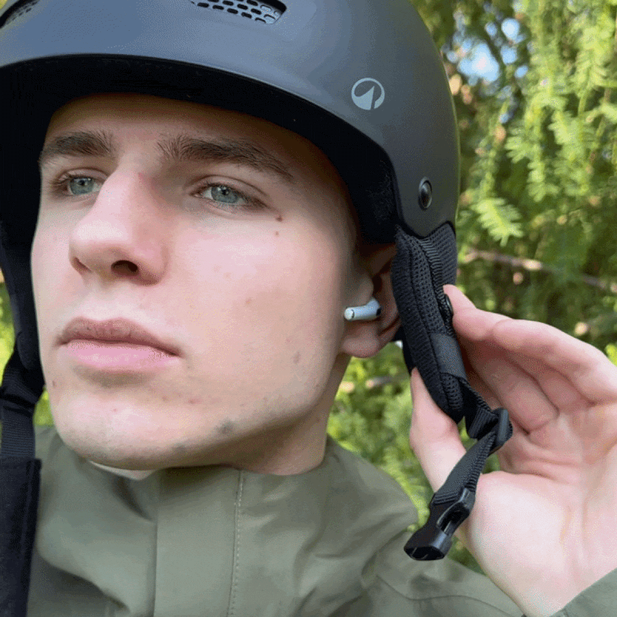 The Ski Tunes headband worn flat under a ski helmet with goggles on top